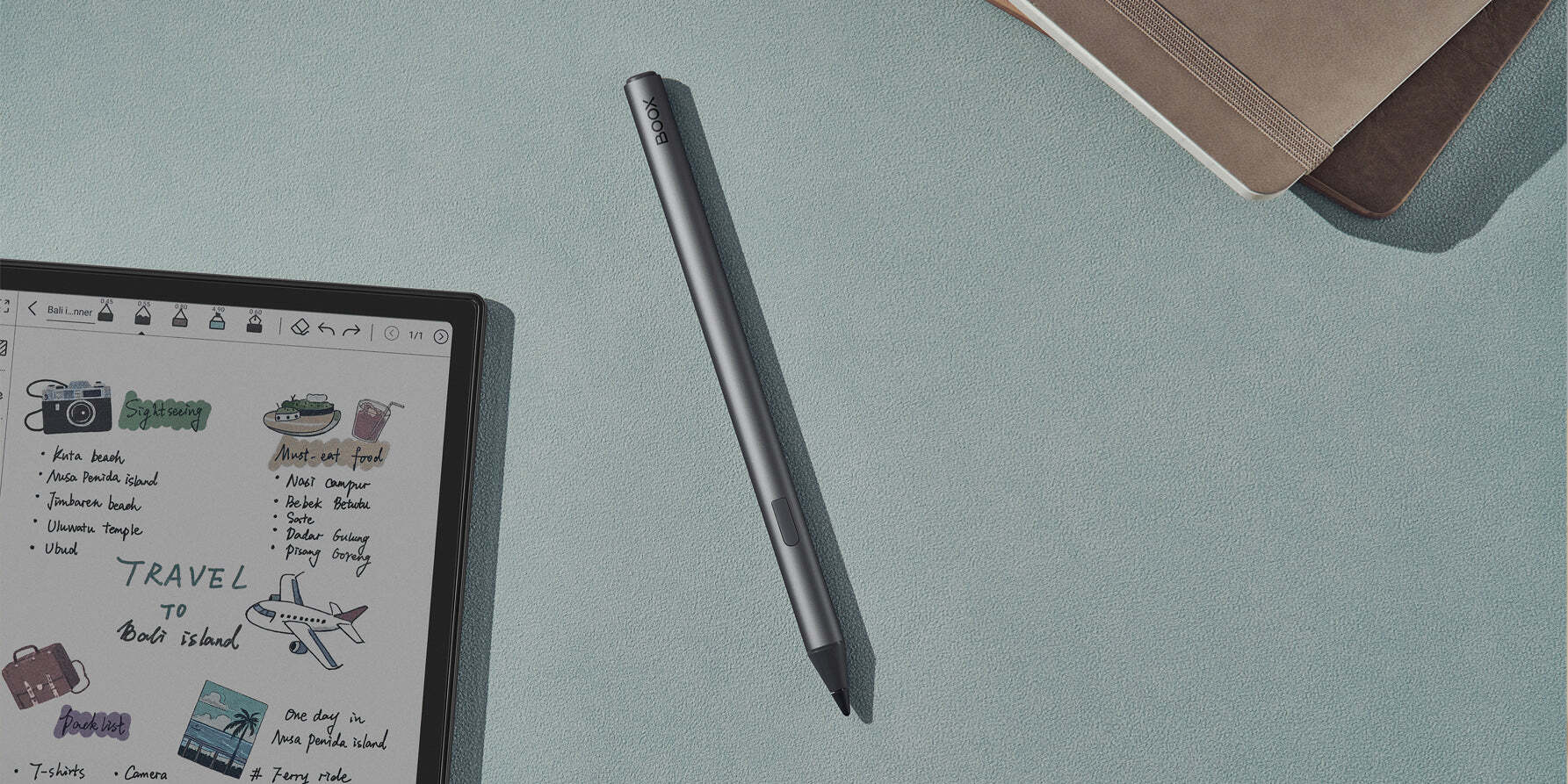 BOOX InkSense Stylus – masa üzerinde yatay konumda duran kalem ve yanındaki tablette dijital çizim ekranı görünümü